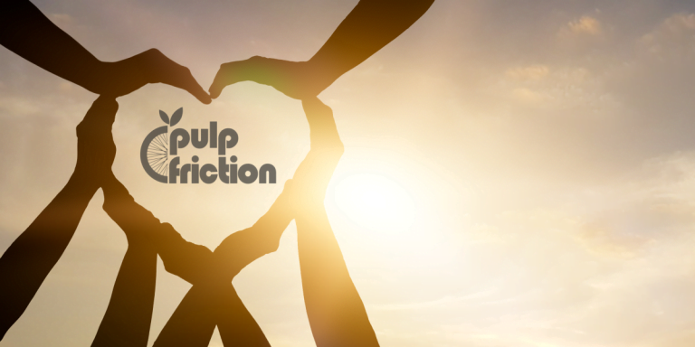International day of charity image. Hands making a heart with the pulp friction logo in the middle.