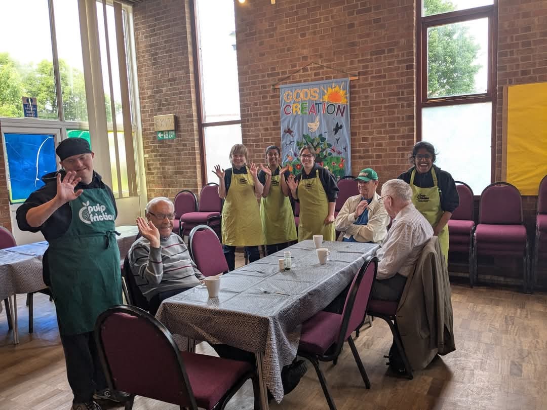 People waving at Thursdays Community Meal