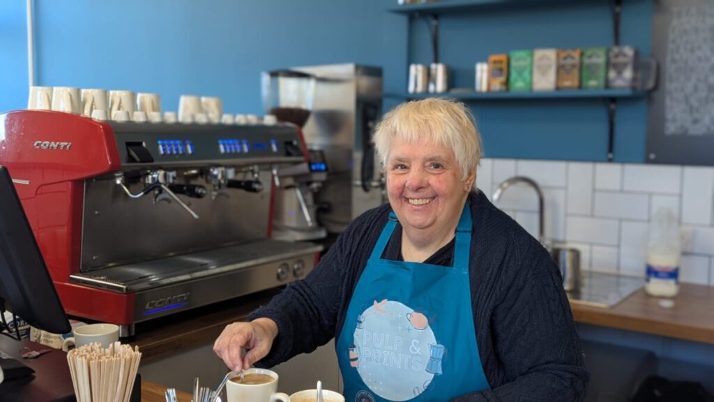 Marion working behind the coffee counter at Pulp and Prints
