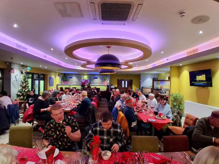 Pulp Friction members, staff, volunteers and parents enjoying a christmas meal