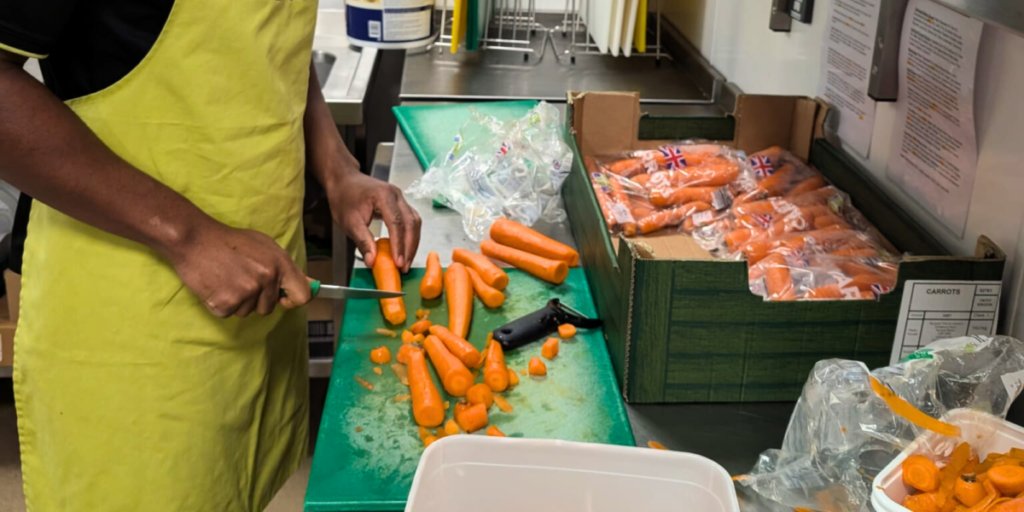 Member prepping carrots to reduce food waste